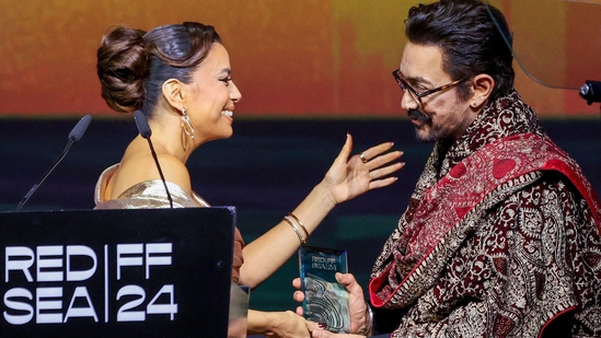 Bollywood actor Aamir Khan (R) receives an award from US actress Eva Longoria during the 4th edition of the Red Sea International Film Festival at Culture Square in Jeddah on December 5, 2024.(AFP)