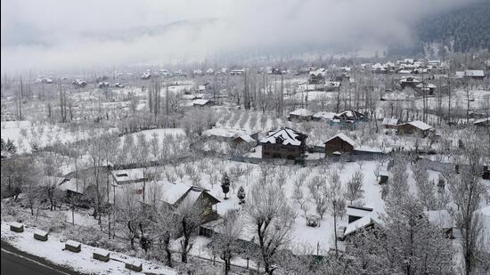 Houses covered in snow after the plains of Kashmir received the season's first snowfall after a long dry spell on December 12. (PTI Photo) Houses covered in snow after the plains of Kashmir received the season's first snowfall after a long dry spell on December 12. (PTI Photo)