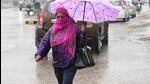 A woman makes her way through puddled roads in Chandigarh on Monday. (kESHAV SINGH/HT) A woman makes her way through puddled roads in Chandigarh on Monday. (kESHAV SINGH/HT)