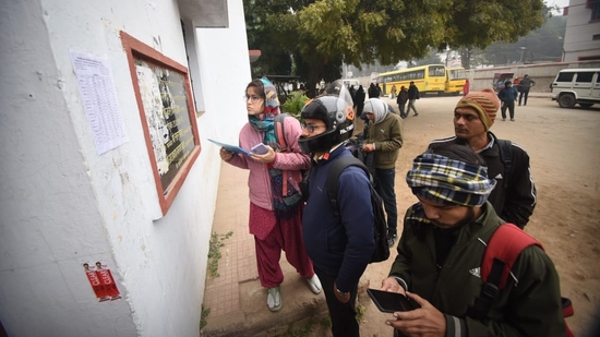 Applicants checking details before appearing for Bihar Public Service Commission (BPSC) 70th Prelims Exam, at B.N Collegiate Secondary High School, in Patna. (Santosh Kumar )