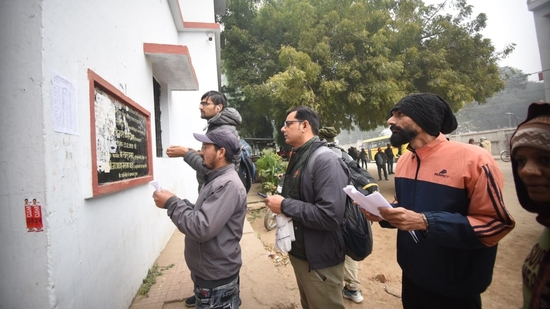 Applicants waiting in a queue outside examination center before entering an examination center to appear for the Bihar Public Service Commission (BPSC) 70th Prelims Exam, at B.N Collegiate Secondary High School, in Patna. (Santosh Kumar )