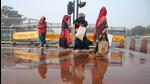Workers navigate a waterlogged pavement at Kartavya Path. (Vipin Kumar/HT Photo) Workers navigate a waterlogged pavement at Kartavya Path. (Vipin Kumar/HT Photo)