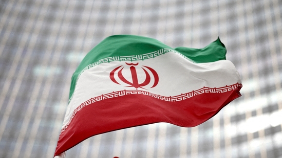 Iranian flag flies in front of the UN office building, (REUTERS)
