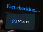 This photo illustration created on January 8, 2025, in Brussels, shows the media giant Meta's logo displayed on a smartphone and screen displaying the words This photo illustration created on January 8, 2025, in Brussels, shows the media giant Meta's logo displayed on a smartphone and screen displaying the words