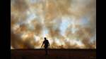 (FILES) A man is seen in front of smoke rising from an illegally lit fire on a maize field that borders a rainforest reserve, in Sinop, Mato Grosso state, Brazil, on August 9, 2020. . (Photo by CARL DE SOUZA / AFP) (AFP) (FILES) A man is seen in front of smoke rising from an illegally lit fire on a maize field that borders a rainforest reserve, in Sinop, Mato Grosso state, Brazil, on August 9, 2020. . (Photo by CARL DE SOUZA / AFP) (AFP)