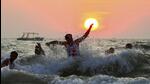 Tourists enjoy at the Arabian Sea as the Sun sets for the last time in 2024, at Calangute Beach in North Goa, on December 31, 2024. (PTI) Tourists enjoy at the Arabian Sea as the Sun sets for the last time in 2024, at Calangute Beach in North Goa, on December 31, 2024. (PTI)