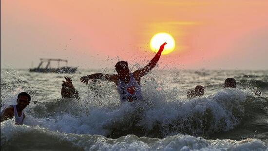 Tourists enjoy at the Arabian Sea as the Sun sets for the last time in 2024, at Calangute Beach in North Goa, on December 31, 2024. (PTI) Tourists enjoy at the Arabian Sea as the Sun sets for the last time in 2024, at Calangute Beach in North Goa, on December 31, 2024. (PTI)