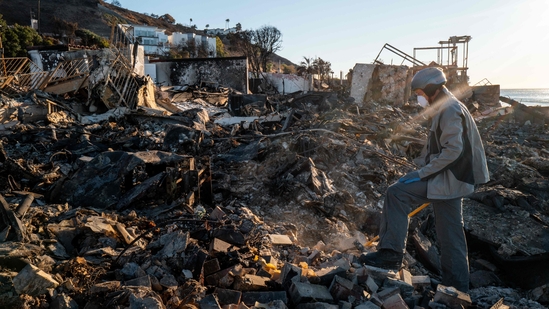 The blazes are expected to rank among the costliest in modern US history. As of early Monday, the Eaton fire was 33% contained and the Palisades blaze was 14% contained.(Getty Images via AFP)