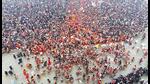 Flower petals being showered on devotees during the first ‘Amrit Snan’ at the Mahakumbh on Makar Sankranti, at Sangam in Prayagraj, Tuesday. (PTI Photo) Flower petals being showered on devotees during the first ‘Amrit Snan’ at the Mahakumbh on Makar Sankranti, at Sangam in Prayagraj, Tuesday. (PTI Photo)