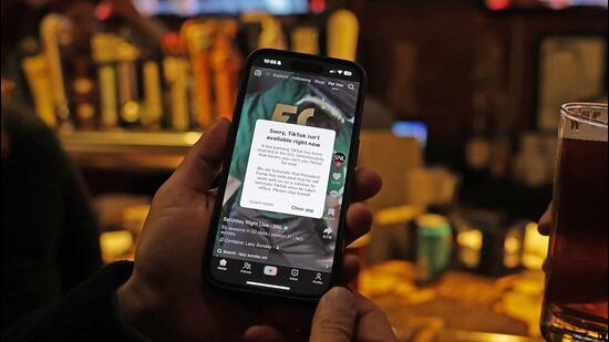 A TikTok user holds a phone showing the screen of the social media app in Washington, DC, on Sunday. (AFP) A TikTok user holds a phone showing the screen of the social media app in Washington, DC, on Sunday. (AFP)
