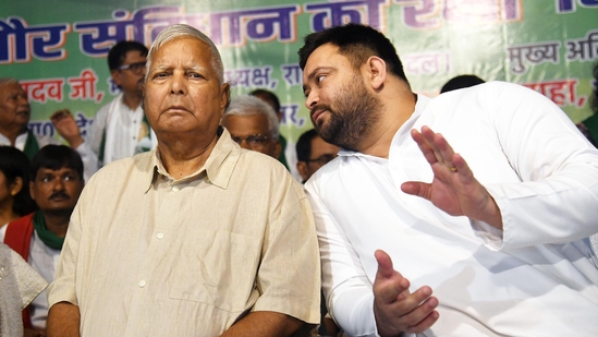 RJD leader Tejashwi Yadav with RJD chief Lalu Prasad at RJD office in Patna.(Santosh Kumar/HT file)