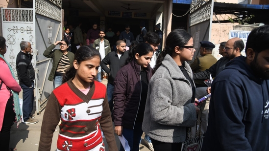Aspirants coming out after appeared in the Common Management Admission Test (CMAT) exam at an examination centre at Patliputra in Patna. (Santosh Kumar )