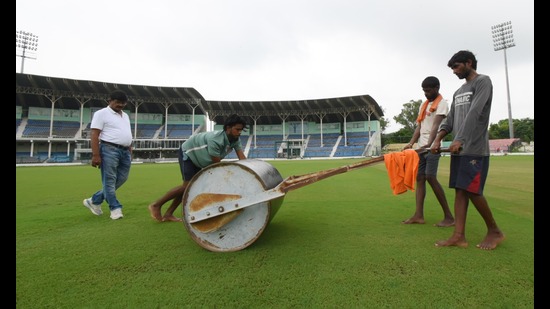 Workers roll the pitch at the Green Park Stadium under the watchful eyes of pitch curator Shiv Kumar. (HT Photo) Workers roll the pitch at the Green Park Stadium under the watchful eyes of pitch curator Shiv Kumar. (HT Photo)