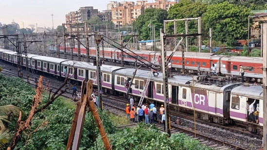 Mumbai weather: Mumbai's local train services on the Central Railway were affected after an overhead equipment pole between Thane and Mulund stations got bent due to strong winds. (HT photo/ Praful Gangurde) Mumbai weather: Mumbai's local train services on the Central Railway were affected after an overhead equipment pole between Thane and Mulund stations got bent due to strong winds. (HT photo/ Praful Gangurde)