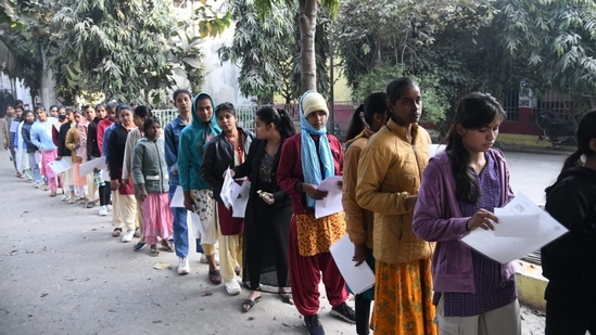 Candidates wait for their turn to enter the exam hall to appear for BSEB Class 12 Board Exam in Patna(Santosh Kumar)