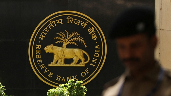 RBI MPC: A police officer walks past the Reserve Bank of India (RBI) logo inside its headquarters in Mumbai, India.(Reuters)