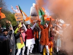 BJP supporters carrying cut outs of Prime Minister Narendra Modi celebrate the Delhi election results on Saturday.(AP) BJP supporters carrying cut outs of Prime Minister Narendra Modi celebrate the Delhi election results on Saturday.(AP)