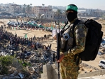 Palestinian Hamas militants stand guard on the day of the release of hostages held in Gaza since the deadly October 7, 2023 attack, as part of a ceasefire and a hostages-prisoners swap deal between Hamas and Israel in Khan Younis, in the southern Gaza Strip,(Reuters)