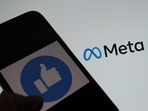 This illustration photo taken in Los Angeles on October 28, 2021, shows a person using Facebook on a smartphone in front of a computer screen showing the META logo.(Chris Delmas/AFP) This illustration photo taken in Los Angeles on October 28, 2021, shows a person using Facebook on a smartphone in front of a computer screen showing the META logo.(Chris Delmas/AFP)