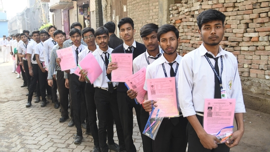 Students waiting in queue outside the St. Dominic Savio's High School in Danapur, Patna to appear in the CBSE Class 10th examination.  (Santosh Kumar )
