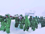 An Indian Army team carries out rescue operations to bring out the trapped construction workers near Mana Pass in Chamoli district of Uttarakhand on Friday. (AP) An Indian Army team carries out rescue operations to bring out the trapped construction workers near Mana Pass in Chamoli district of Uttarakhand on Friday. (AP)