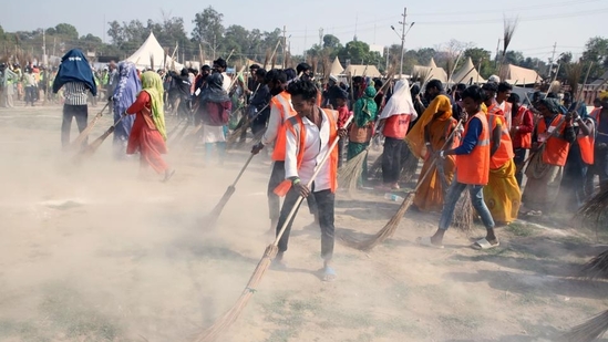 Sanitation workers took to cleaning up the grounds on the banks of the Triveni Sangam where devotees had resided for more than a month(HT Photo)