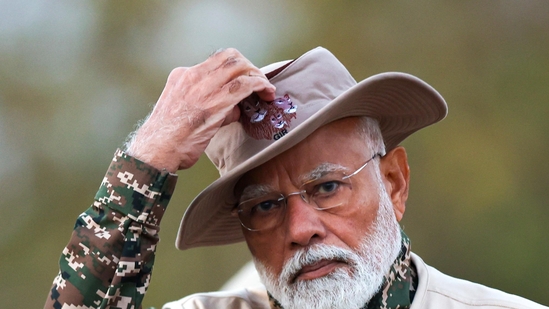 PM Modi was seen wearing a safari outfit and holding a camera to take shots of Gir's Asiatic lions.(X/@narendraModi)