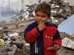 A boy looks on as he eats at a camp sheltering displaced Palestinians set up at a landfill in the Yarmuk area in Gaza City on March 20, 2025.(AFP) A boy looks on as he eats at a camp sheltering displaced Palestinians set up at a landfill in the Yarmuk area in Gaza City on March 20, 2025.(AFP)