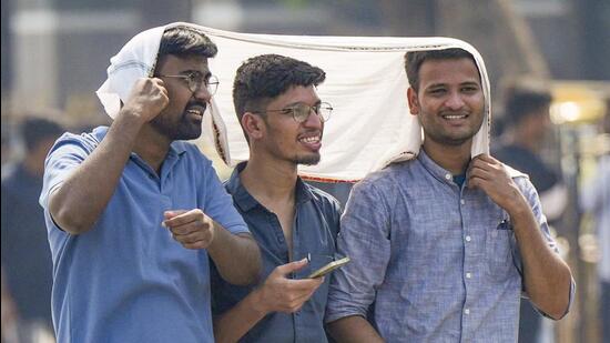 People protect themselves from the heat in Mumbai. (PTI Photo) People protect themselves from the heat in Mumbai. (PTI Photo)