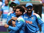 Kuldeep Yadav celebrating a wicket during Champions Trophy with Axar Patel (L) and Virat Kohli