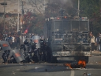 Riot police personnel take cover from stones hurled by pro-monarchist demonstrators during a protest demanding the restoration of Nepal's monarchy, which was abolished in 2008, saying the governments have failed to make any significant changes, in Kathmandu, Nepal, (Reuters) Riot police personnel take cover from stones hurled by pro-monarchist demonstrators during a protest demanding the restoration of Nepal's monarchy, which was abolished in 2008, saying the governments have failed to make any significant changes, in Kathmandu, Nepal, (Reuters)