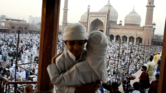 Children rejoice in the holy moment and exchange Eid greetings after offering Namaz. They were seen hugging and celebrating with Jama Masjid in the backdrop, in Delhi.(Sanjeev Verma/HT Photo)
