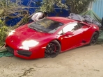 People gather around a Lamborghini car after it allegedly hit people in Noida on Sunday. (PTI) People gather around a Lamborghini car after it allegedly hit people in Noida on Sunday. (PTI)