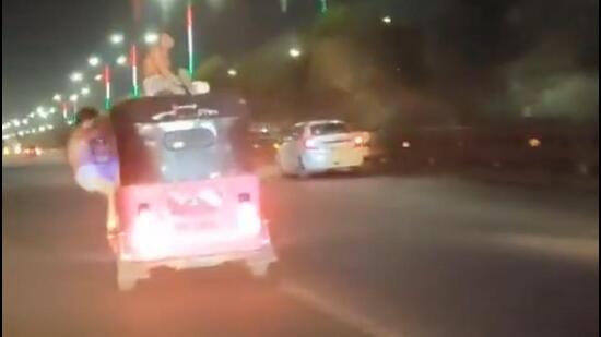 A screengrab from a video shows the men performing the stunts on the pink autorickshaw. (HT Photo) A screengrab from a video shows the men performing the stunts on the pink autorickshaw. (HT Photo)