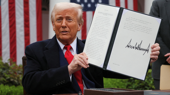 US President Donald Trump holds a signed executive order on tariffs, in the Rose Garden at the White House in Washington DC, US, on April 2, 2025.(Reuters)