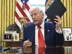 President Donald Trump holds an executive order in the Oval Office of the White House. AP/PTI(AP04_10_2025_000017B)(AP) President Donald Trump holds an executive order in the Oval Office of the White House. AP/PTI(AP04_10_2025_000017B)(AP)