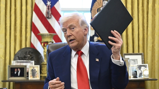 President Donald Trump holds an executive order in the Oval Office of the White House. AP/PTI(AP04_10_2025_000017B)(AP) President Donald Trump holds an executive order in the Oval Office of the White House. AP/PTI(AP04_10_2025_000017B)(AP)