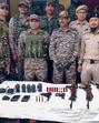 Security personnel with arms and ammunition recovered during a search operation in Kangpokpi district. (Manipur Police) Security personnel with arms and ammunition recovered during a search operation in Kangpokpi district. (Manipur Police)