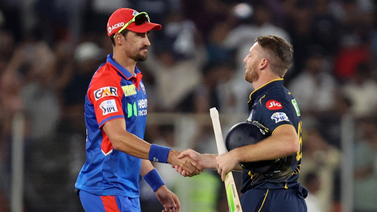 Gujarat Titans' Jos Buttler shakes hands with Delhi Capitals' Mitchell Starc after the match (REUTERS)