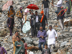 A groom along with his relatives walks towards his destination after roads were blocked by debris following heavy rain trigged landslides and flash flood, in Ramban district.(PTI) A groom along with his relatives walks towards his destination after roads were blocked by debris following heavy rain trigged landslides and flash flood, in Ramban district.(PTI)
