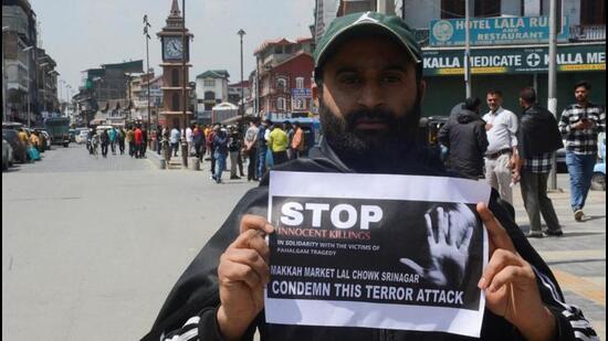 A Kashmiri trader holds a sign during a protest in Srinagar on Wednesday, a day after the terror attack on tourists in south Kashmir’s Pahalgam. (Reuters photo) A Kashmiri trader holds a sign during a protest in Srinagar on Wednesday, a day after the terror attack on tourists in south Kashmir’s Pahalgam. (Reuters photo)