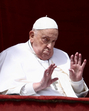 Pope Francis gestures from a balcony as the Pope Francis gestures from a balcony as the