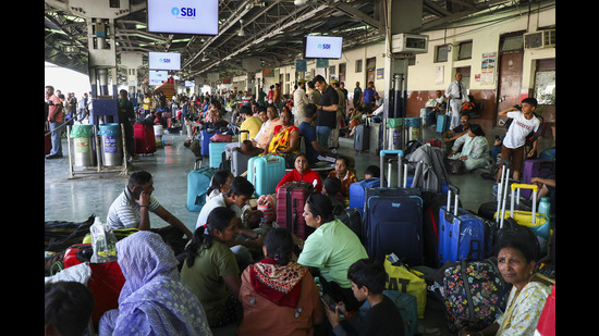 Tourists wait at Jammu railway station after returning from Kashmir on Thursday. (PTI) Tourists wait at Jammu railway station after returning from Kashmir on Thursday. (PTI)