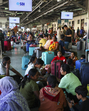 Tourists wait at Jammu railway station after returning from Kashmir on Thursday. (PTI) Tourists wait at Jammu railway station after returning from Kashmir on Thursday. (PTI)
