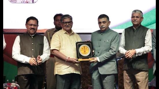Punjab governor Gulab Chand Kataria presenting the National Excellence Award to retired IPS officer RK Pachnanda. (HT Photo)