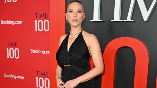 At Time100 Gala 2025, black dresses were a popular choice with Scarlett Johansson also opting for a slim fitting black halterneck dress. She tied her hair in a sleek top bun and accessorised with statement gold jewellery.(AFP)