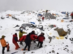 In this photograph, rescuers use a makeshift stretcher to carry an injured person after an avalanche triggered by an earthquake flattened parts of Everest Base Camp. Nepal cracks down: Only elite climbers will touch Everest’s summit.(Photo by Roberto SCHMIDT / AFP) In this photograph, rescuers use a makeshift stretcher to carry an injured person after an avalanche triggered by an earthquake flattened parts of Everest Base Camp. Nepal cracks down: Only elite climbers will touch Everest’s summit.(Photo by Roberto SCHMIDT / AFP)