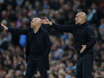 Liverpool manager Arne Slot and Manchester City manager Pep Guardiola during a match.