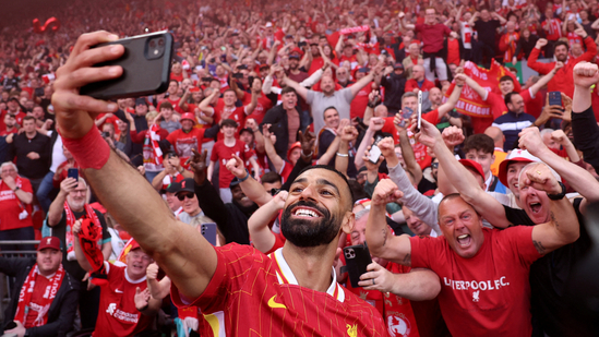 Mohamed Salah takes a selfie with fans.(REUTERS)