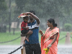 Visitors at Kartavya Path amid rain in New Delhi. The IMD also warned of hailstorm damaging crops and injuring people/cattle standing at open spaces.(Photo by Sanjeev Verma/Hindustan Times) Visitors at Kartavya Path amid rain in New Delhi. The IMD also warned of hailstorm damaging crops and injuring people/cattle standing at open spaces.(Photo by Sanjeev Verma/Hindustan Times)